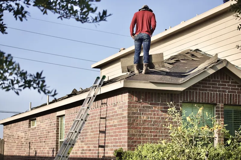 Professional roofer working on a residential roof in Jarrell